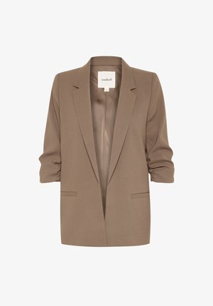 Blazer strutturato marrone con maniche arrotolate, apertura frontale, tasche laterali e una texture di tessuto morbido. L'etichetta recita "soaked."