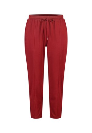 Pantalon décontracté rouge texturé avec ceinture élastique et cordon de serrage à l'avant, avec des coutures verticales subtiles et une coupe fuselée.