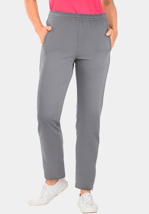 Gray stretch pants with an elastic waistband, side pockets, and a tapered leg design, paired with white sneakers.