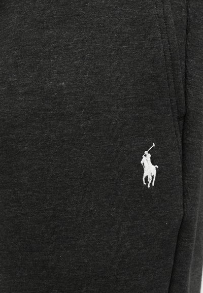 Ύφασμα από μαύρο βαμβακερό μείγμα με απαλό υφή. Διαθέτει ένα μικρό λευκό κεντημένο λογότυπο αλόγου με παίκτη πόλο στην αριστερή πλευρά.