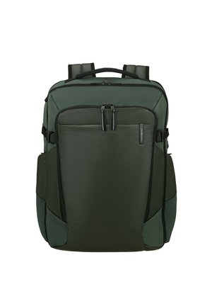Green backpack with a textured surface, dual zippered compartments, adjustable padded shoulder straps, and side pockets for storage.