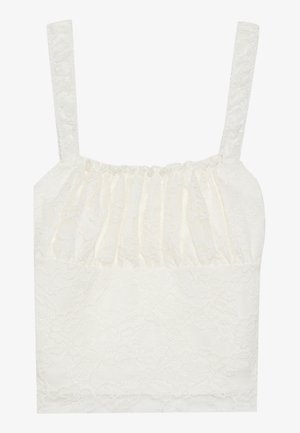 Blonde topp med rynket tekstur, tynne stropper og en myk hvit farge. Har blomster mønster og en glatt nedre del.