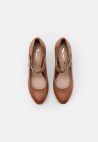 Chaussures Mary Jane en cuir marron avec des brides à boucles, taille 37, vues de dessus sur fond blanc.