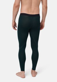 Herren-Fitnessleggings aus dunkelgrünem Stoff. Mit einem schwarzen Bund, glatter Textur und verstärkten Nähten für Langlebigkeit.