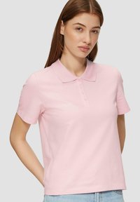 Pale pink polo shirt met een kraag, korte mouwen en een knoopsluiting. Gemaakt van gladde stof, met een eenvoudig, klassiek design.