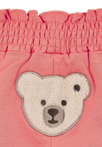 Pantaloni corti in tessuto rosa con vita arricciata. Presentano un'applique in texture a forma di faccia di orso bianco con dettagli ricamati in grigio e nero.