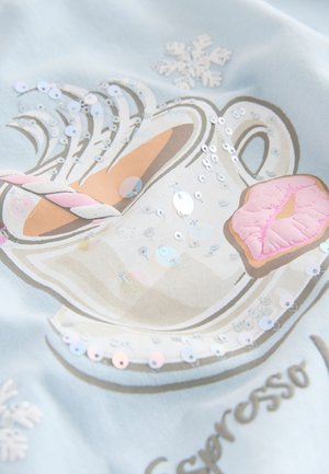 Light blue fabric featuring a coffee cup illustration with sequins, a pink lip print, and snowflake accents. Designs are printed with subtle textures.