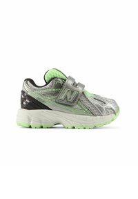 Gray athletic shoe featuring a mesh upper with green accents, Velcro strap, and a textured sole with bright green highlights.