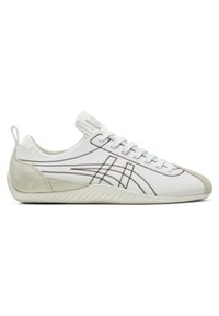 White athletic shoe with suede accents, intricate stitching details, and a textured rubber sole. Features a low-top design and lace closure.