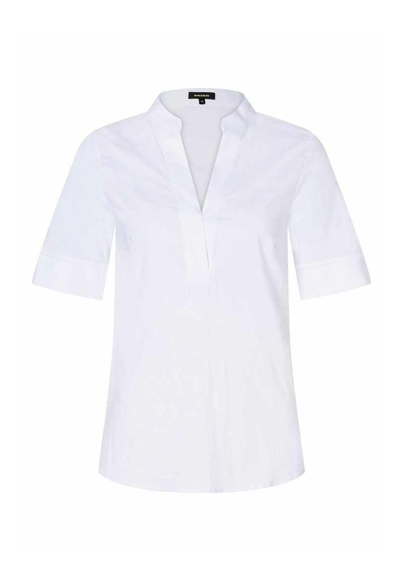 White cotton blouse featuring a V-neck, short sleeves with rolled cuffs, and a relaxed fit. Smooth texture and minimal detailing.