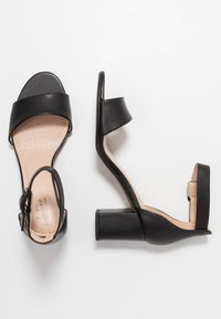 Clarks Sandaalit nilkkaremmillä - black