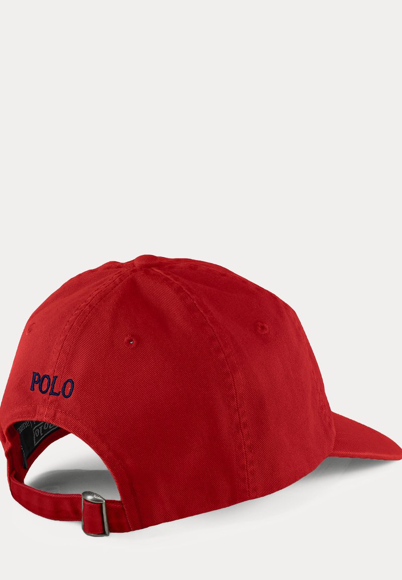 Red adjustable baseball cap with metal buckle and "POLO" embroidered in black on the back, shown from rear and side angle.