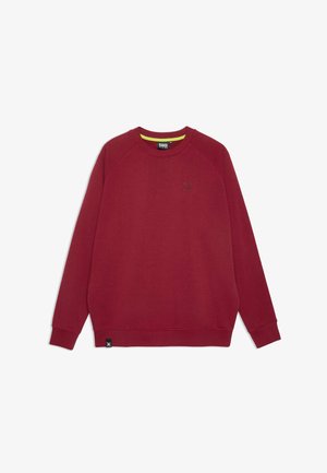 Bordeauxrode trui met een geribde ronde hals, raglanmouwen en een gestructureerd logo op de borst. Voorzien van een contrasterende gele binnenkraag.