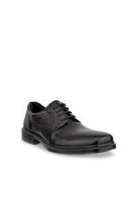 Chaussure habillée pour homme en cuir noir avec fermeture à lacets, bout rond et petit talon, présentée sur un fond blanc.