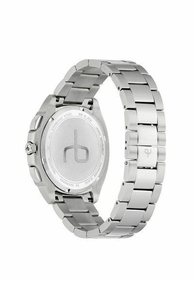 Ceas din oțel inoxidabil cu un finisaj polisat, carcasă rotundă și brățară cu linkuri. Partea de spate are un logo gravat și detalii despre rezistența la apă.