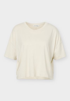 T-shirt ample à manches courtes de couleur crème avec encolure ronde, fabriqué en tissu doux, présenté sur un fond blanc.