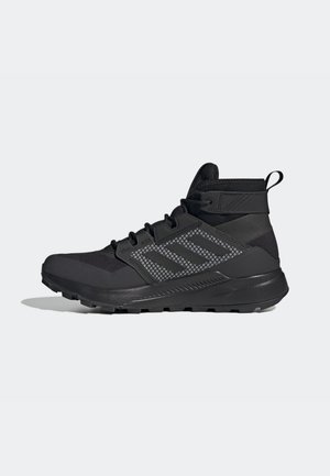 Black high-top athletic sneaker with textured side panels, lace-up front, ankle strap, and rugged outsole on a light background.