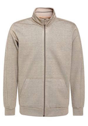 Felpa zip leggera di colore beige chiaro con colletto alto, tasche frontali e polsini a coste. Realizzata in tessuto testurizzato con un motivo sottile.