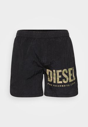Black shorts made of lightweight fabric with a crinkled texture. Features a large yellowed logo reading "DIESEL FOR SUCCESSFUL LIVING."