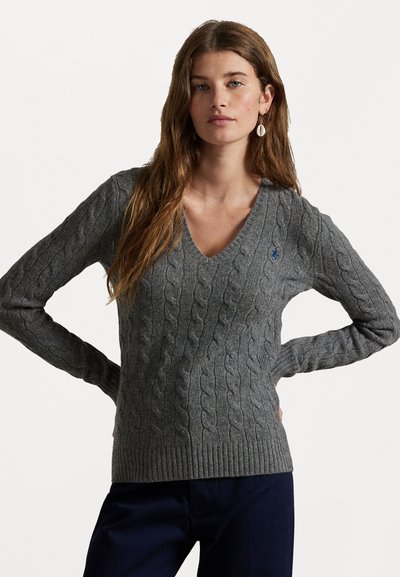 Grauer Strickpullover mit Zopfmuster und V-Ausschnitt, gerippten Bündchen und Saum, mit kleinem blauem Logo auf der Brust. Weiche Textur und figurbetontes Design.