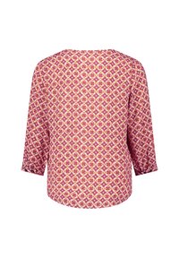 Long-sleeve blouse featuring a floral and geometric pattern in shades of pink, orange, and cream, with a round neckline and loose fit.