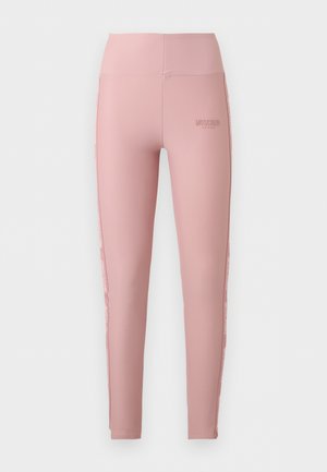 Pink high-waist Moschino Active leggings with slim fit and branded text along the sides and near the waistband.