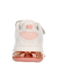 White sneaker with a textured mesh upper, pink accents, dotted design on heel, and a transparent, cushioned sole. Velcro strap included.