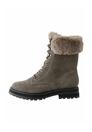Suede ankle boot in taupe with a fur-lined cuff, round toe, lace-up front, metal eyelets, and a black ridged sole for traction.