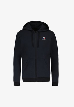 Sweat à zip marine avec deux poches avant, une capuche avec cordon de serrage et un logo sur la poitrine gauche. Les poignets et le bas côtelés ajoutent de la texture.