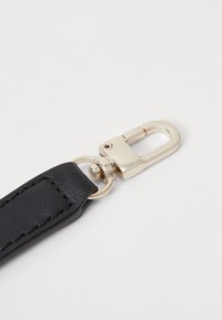 Black leather strap featuring a gold-tone metal clip with a secure closure and textured surface detail. Suitable for various accessories.