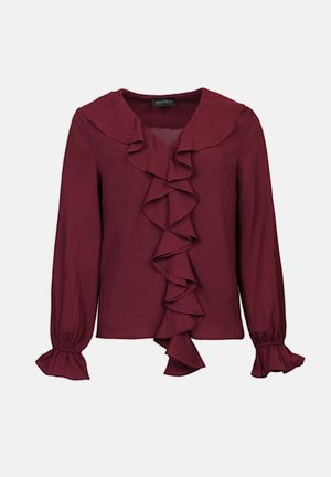 Maroon blouse with long sleeves, ruffled front and collar, textured fabric, and flared cuffs. Designed for a fitted silhouette.