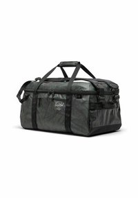 Sac de sport noir et vert foncé avec un motif de feuilles texturé, deux poignées supérieures, une bandoulière réglable et un compartiment principal zippé.