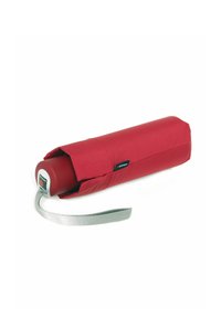 Red compact umbrella with a cylindrical design, fabric cover, silver strap, and a round plastic handle featuring a button for opening.
