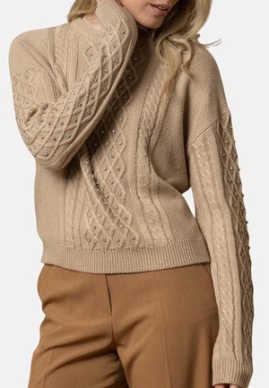 Maglione beige lavorato a maglia con motivi a treccia testurizzati e piccoli perline decorative sulle maniche. Polsini e orlo a coste. Vestibilità ampia.