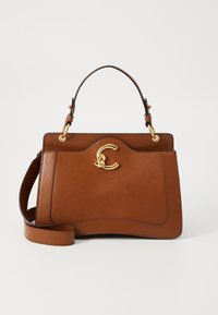 Brown leather handbag with a structured shape, featuring a gold-tone logo clasp and a removable shoulder strap. Smooth texture and minimalistic design.
