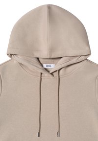 Béžová mikina s kapucí a šňůrkami, měkká textura, žebrované detaily na rukávech a středově umístěná značka uvnitř výstřihu.