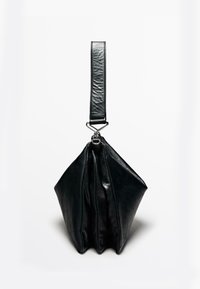 Sac en cuir noir avec un design plié unique, doté d'une large sangle et d'un accent métallique brillant pour l'attache. Texture lisse.