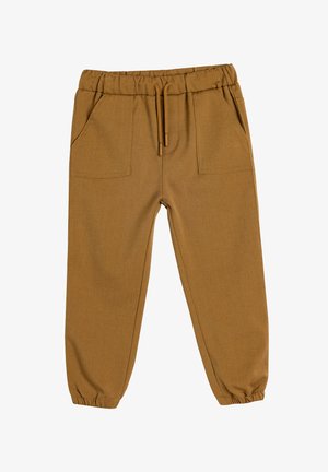 Brune, strækbare stofbukser med elastisk talje, snøre og to forreste lommer. Taperede ben med elastiske manchetter ved anklerne.
