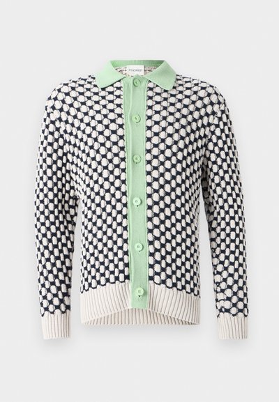 Cardigan with a navy and white polka dot pattern. Features a light green buttoned placket and collar. Ribbed hem and cuffs.