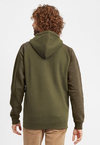 Olive green hoodie with a textured hood and dark green raglan sleeves. Ribbed cuffs and hem, soft fabric, unadorned design.