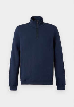 Tumesinine piklike varrukatega pullover, millel on kõrge krae ja esiküljel neljandiku pikkune lukk.