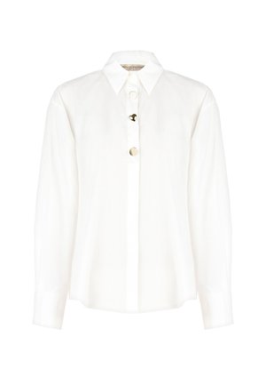 Camicia bianca con colletto, caratterizzata da una fila di bottoni circolari sul davanti. Realizzata in tessuto leggero con maniche lunghe.