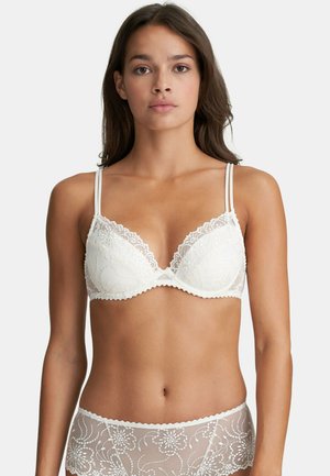 White lace bralette with floral embroidery, soft cups, adjustable straps, and scalloped edges. Paired with matching sheer lace panties.
