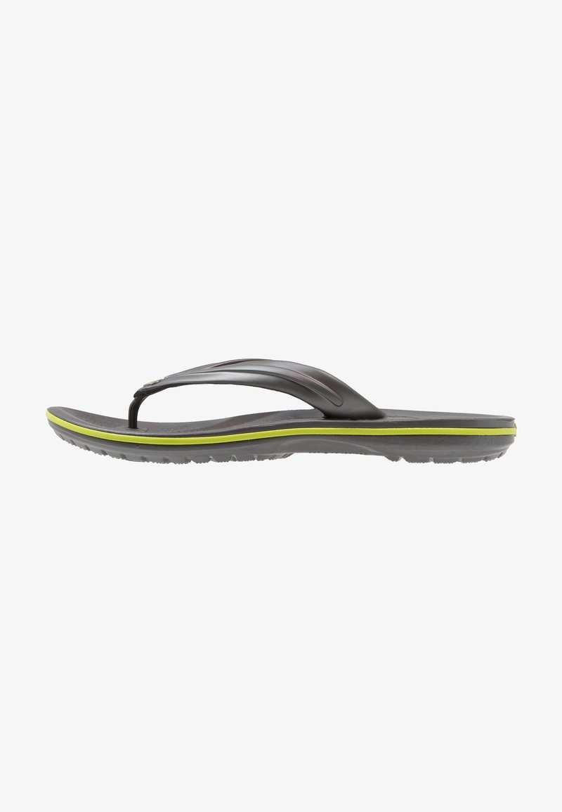 Black flip-flop sandal with a textured footbed, flexible straps, and a green accent band along the sole. Lightweight and casual design.
