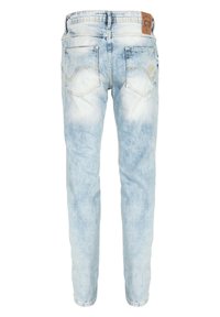 Helle blaue Jeans aus Denim mit einem verwaschenen Finish. Verfügt über zwei Gesäßtaschen mit einem dezenten Design. Enthält ein braunes Etikett am Taillenbund.