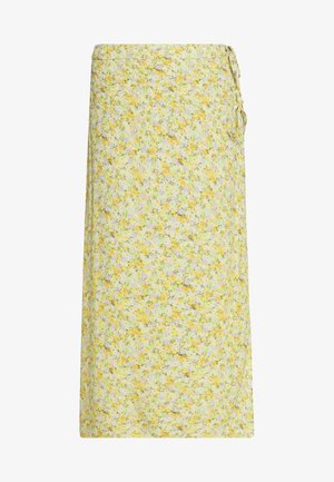 Jupe portefeuille fleurie en jaune pâle, vert et blanc avec de petites fleurs, nouée sur le côté, longueur midi avec coupe droite.