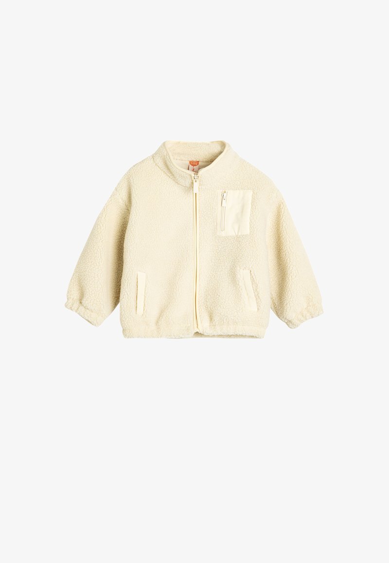 Giacca crema foderata in pile con zip frontale, colletto rialzato e una tasca a toppa. Presenta maniche ampie e una finitura morbida e testurizzata.
