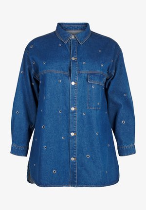 Tumed sinine teksajack, millel on nööbiliist, teravad kraed, pikad varrukad ning väikesed dekoratiivsed metallist silmad üle kogu pinna.