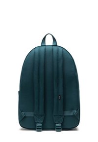 Sac à dos en tissu vert foncé doté de bretelles rembourrées, de deux poignées supérieures et d'un design épuré sans logos ni embellissements visibles.