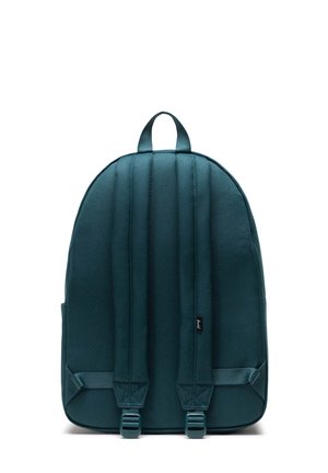 Ryggsäck i mörk teal tyg med vadderade axelremmar, dubbla handtag på toppen och en strömlinjeformad design utan synliga logotyper eller dekorationer.